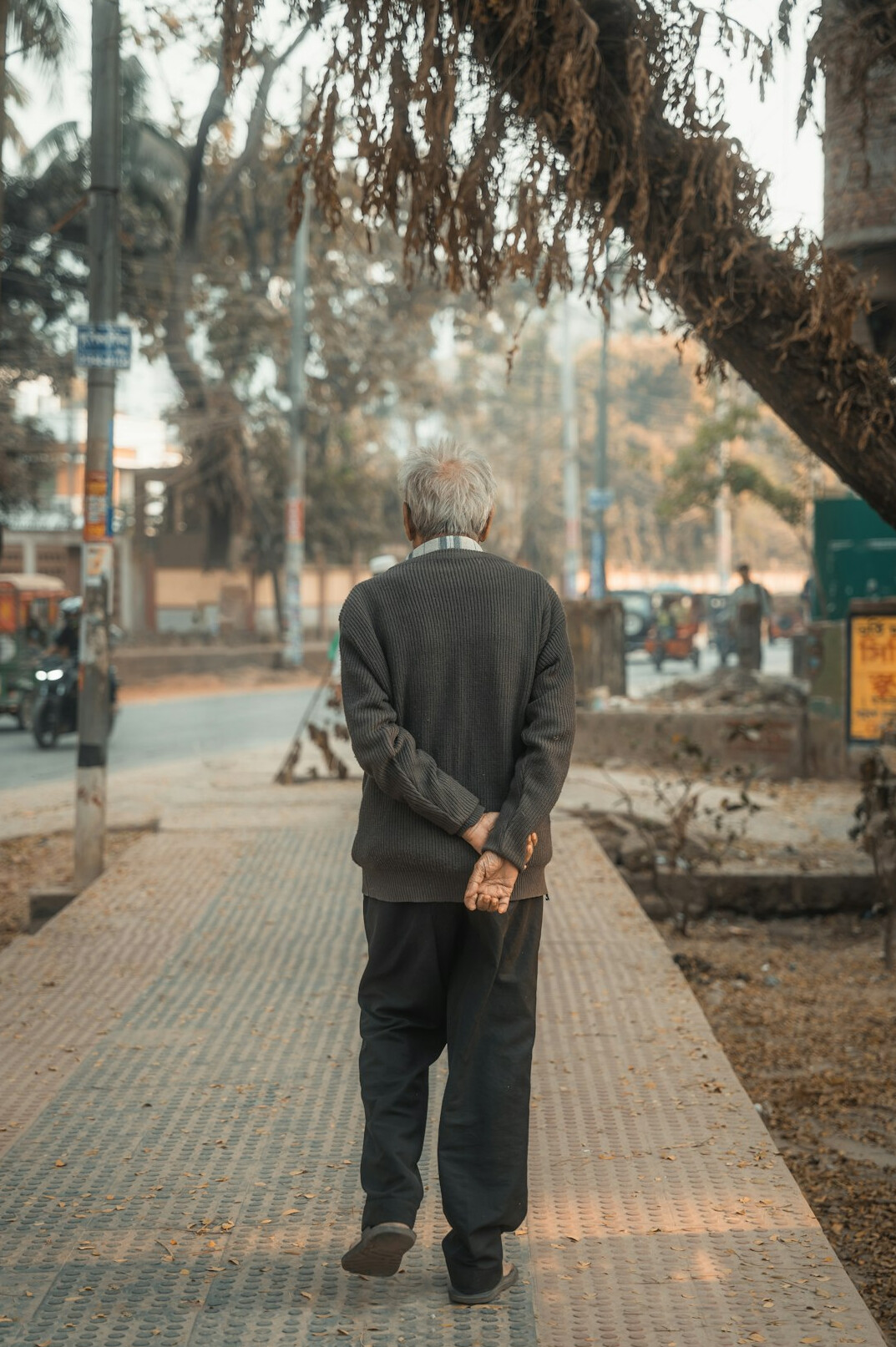 Close portrait of an elderly man standing on a city sidewalk